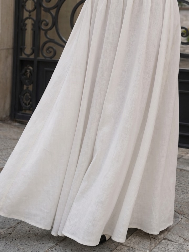 Fashionable women's fitted white midi dress with a sleek halter neck design, perfect as a sleeveless summer dress.