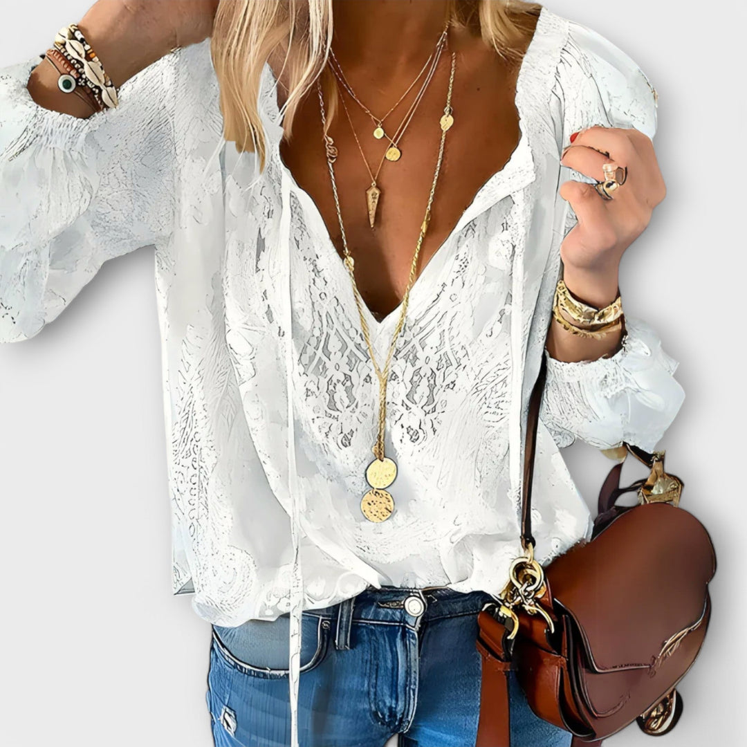 Elegant women's white lace blouse with a stylish tie-neck, perfect for sophisticated workwear or versatile spring fashion.