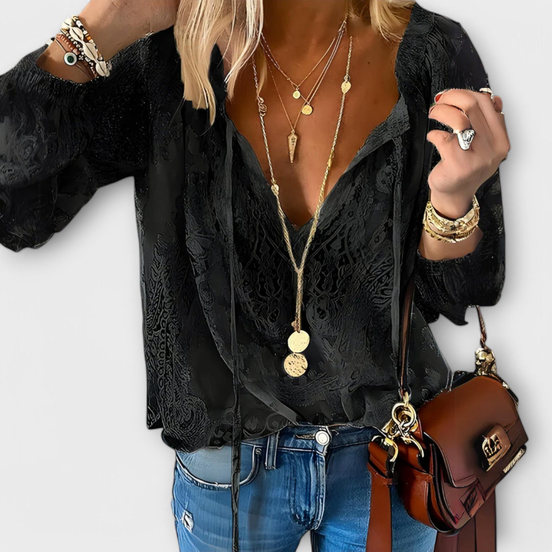 Boho chic women's lace top with a delicate tie-neck, ideal for casual summer outfits or elegant versatile fashion.