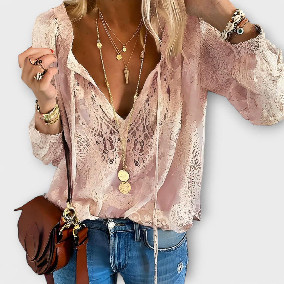 Fashionable women's lace blouse, soft and airy, with a chic tie-neck, blending casual comfort with elegant style.
