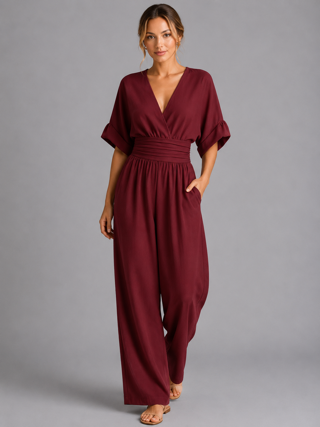 Close-up of a women's elegant wide-leg jumpsuit, highlighting the stylish cinched waist detail, great for any event.