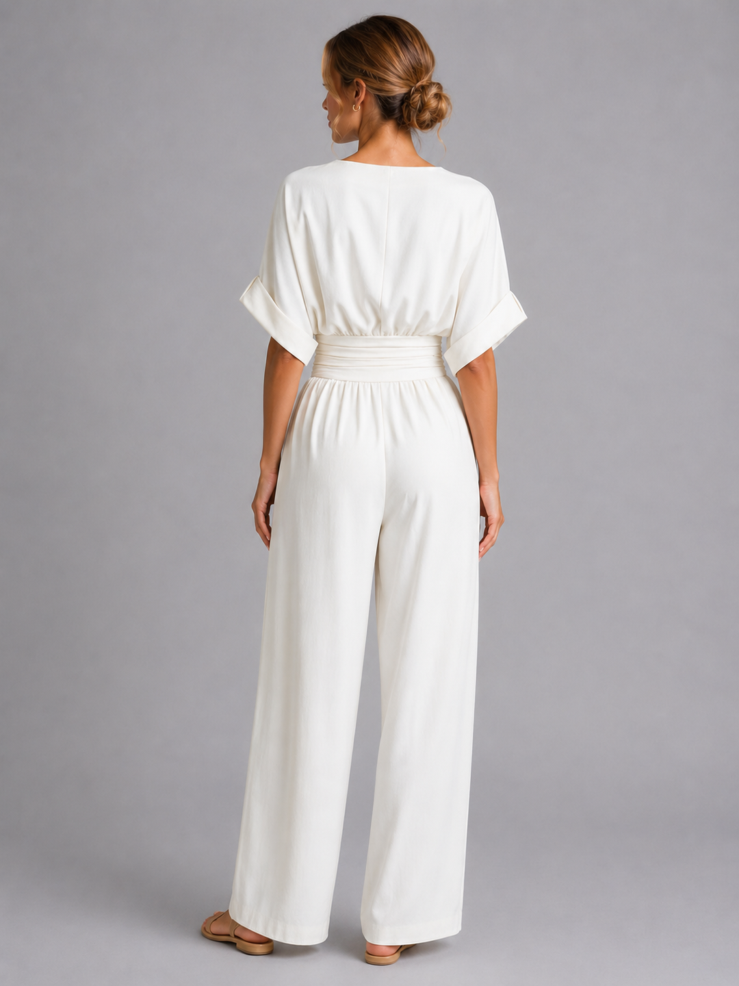 Stylish women's one-piece wide-leg jumpsuit with a cinched waist, offering a chic and comfortable fashion statement.