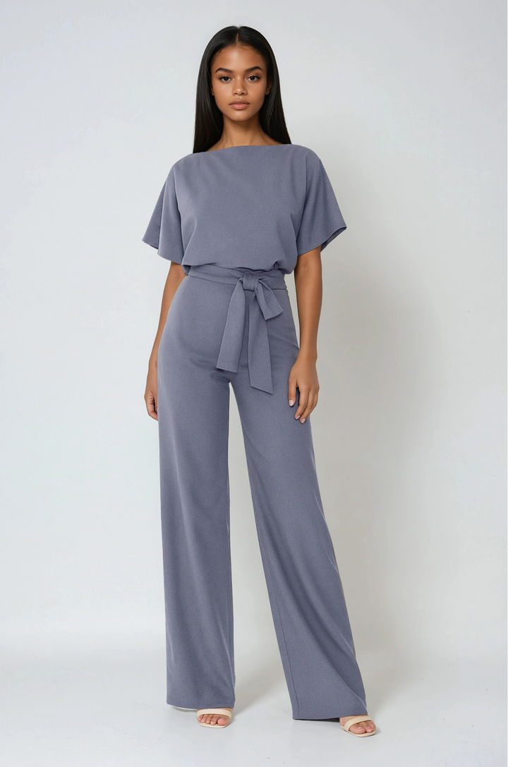 Elegant women's wide-leg jumpsuit with a flattering tie waist, perfect for day to night spring & summer style.