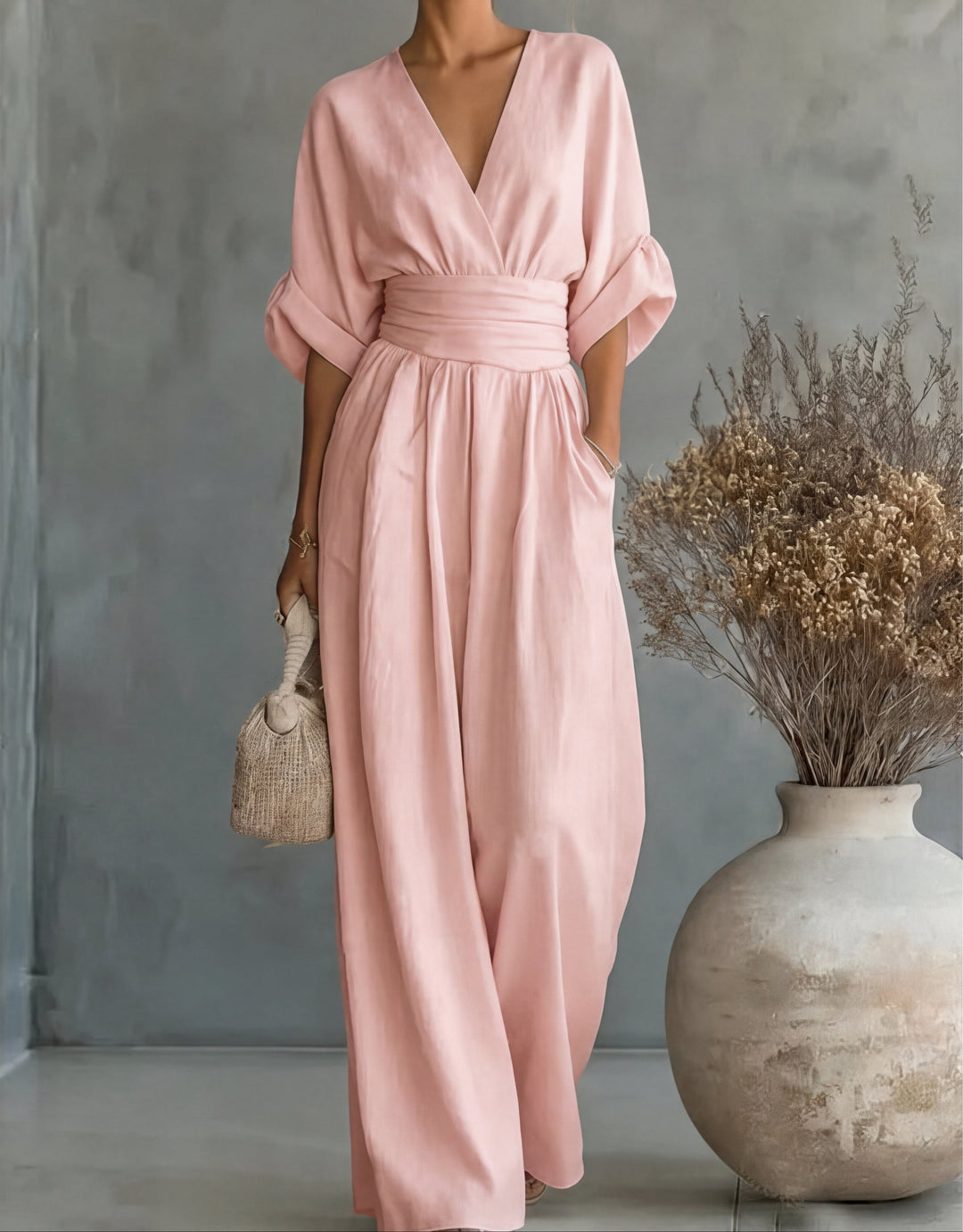 Make a statement in this elegant women's wide-leg jumpsuit with a flattering wrap bodice. Chic fashion.
