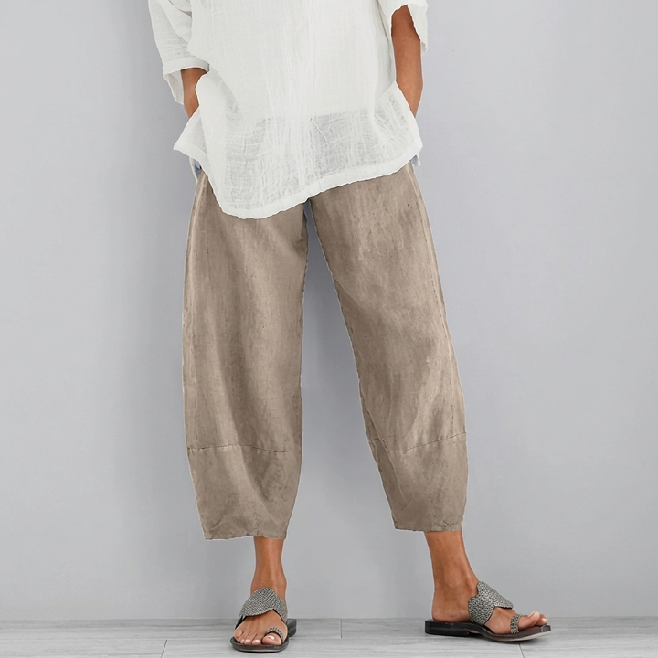 Luxurious women's wide-leg satin trousers, elegant and stylish. High-rise formal pants for chic evening wear.