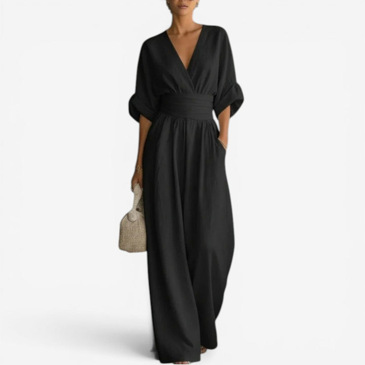 Women's elegant V-neck jumpsuit with stylish wide sleeves. A fashionable one-piece for confident women.