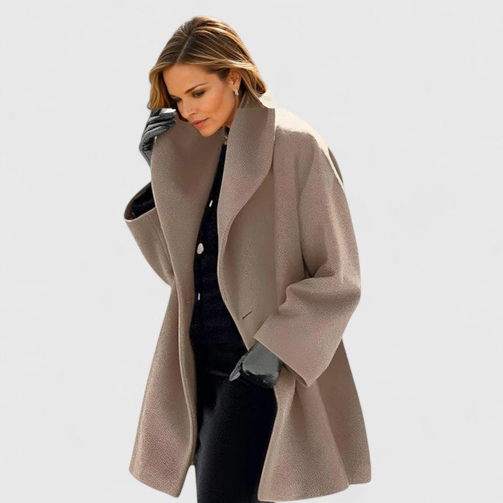 Stylish women's long winter coat, showcasing its elegant design and relaxed fit. Perfect warm outerwear.