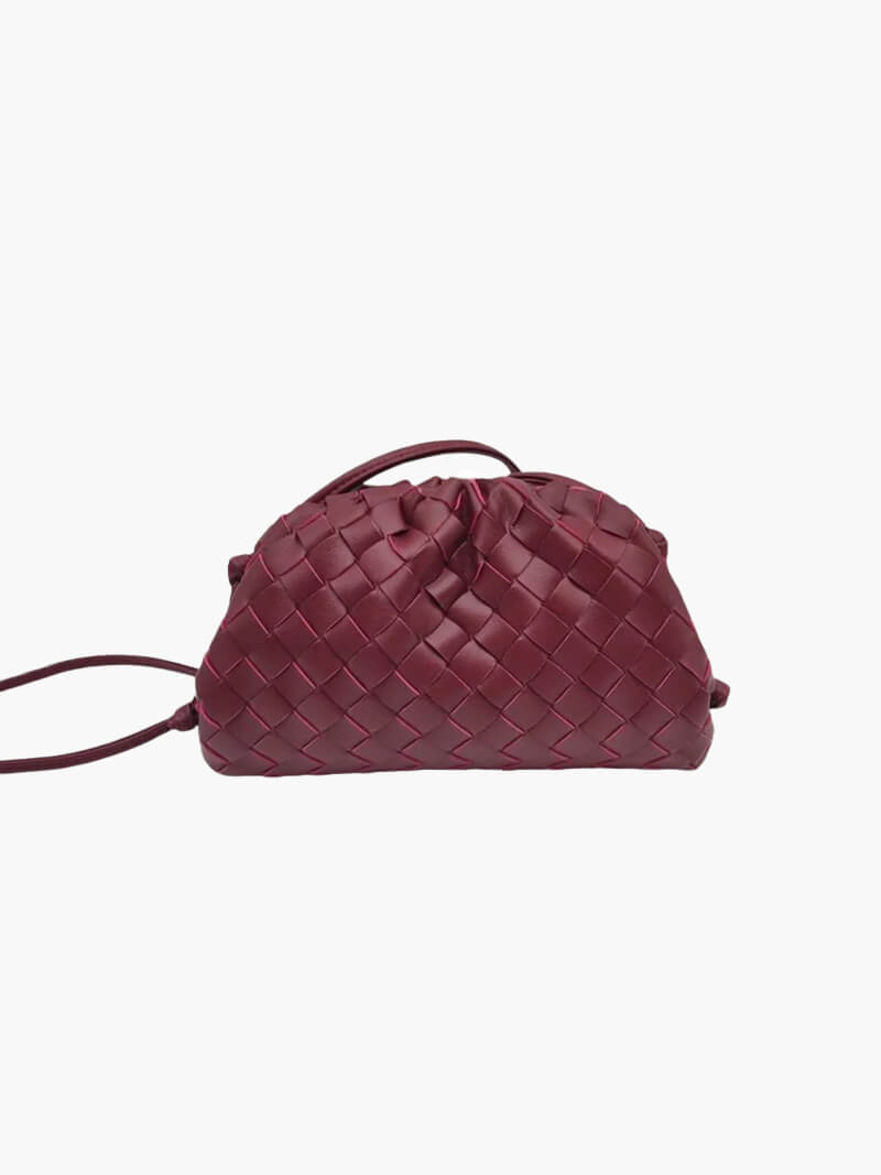 Close-up of the intricate woven texture on a women's elegant shoulder bag. Modern minimalist design.