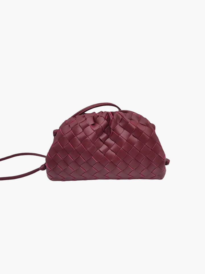 Close-up of the intricate woven texture on a women's elegant shoulder bag. Modern minimalist design.