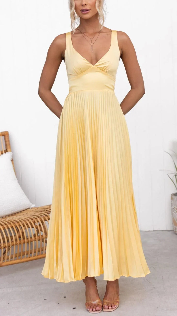 Flowy yellow V-neck maxi dress for women, featuring elegant pleats, ideal for a stylish summer look.