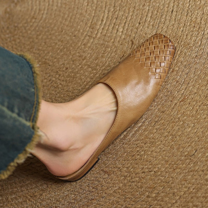 Women's chic slip-on mules with a stylish woven texture and modern square toe design.