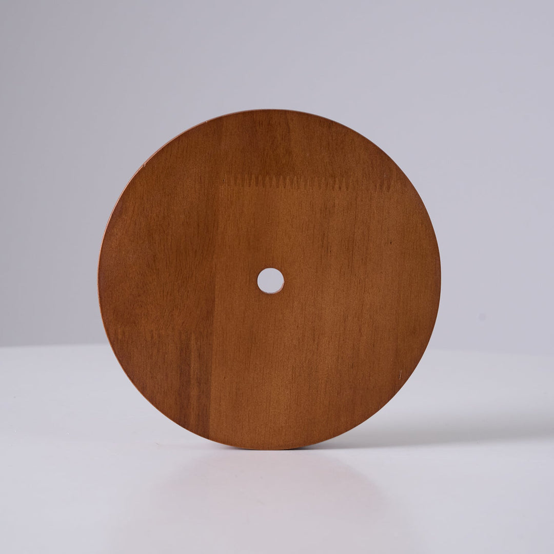 Yarelle pendant light in daylight, highlighting natural travertine & wood textures. Modern home lighting accent.