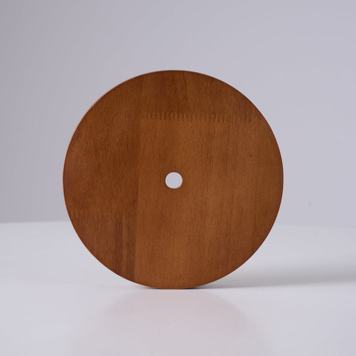Yarelle pendant light in daylight, highlighting natural travertine & wood textures. Modern home lighting accent.