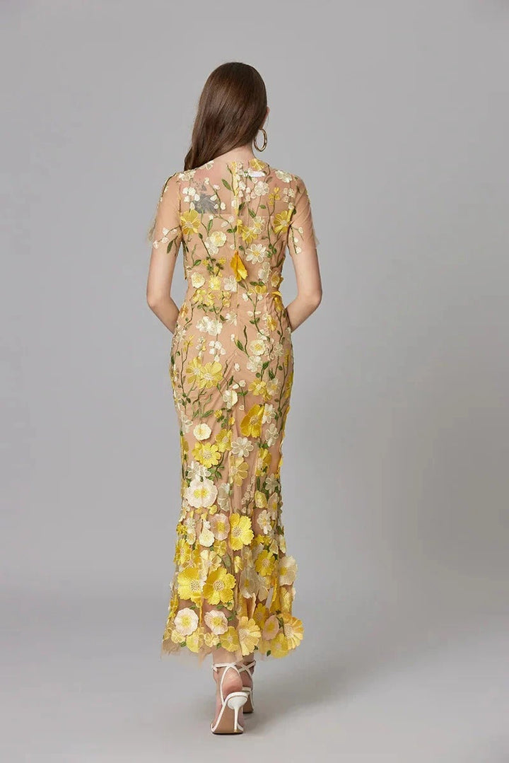 Stunning yellow mesh maxi dress for women, featuring exquisite embroidery. Elegant sleeveless design for events.