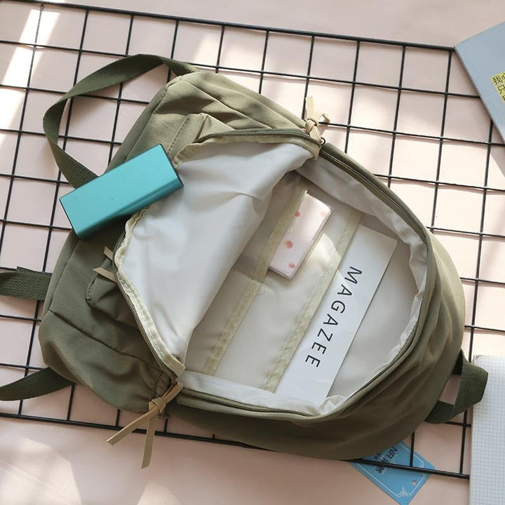 Stylish durable backpack for work & school, showcasing its main compartment & external pockets.
