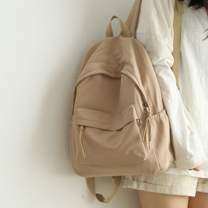 Close-up of the durable, water-resistant fabric on a stylish everyday backpack, built to last.