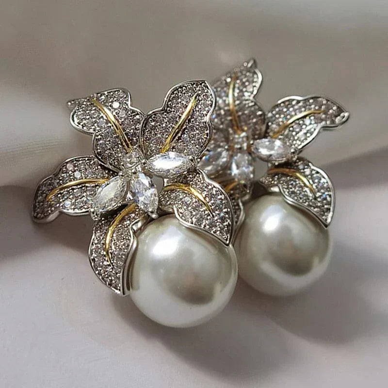 Exquisite women's flower pearl drop earrings. Elegant fashion jewelry with intricate floral design and lustrous pearls.