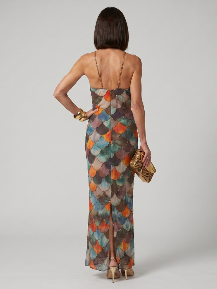 Women's elegant fitted maxi dress, a sleeveless halter style with a unique shimmering scale pattern. Perfect party wear.