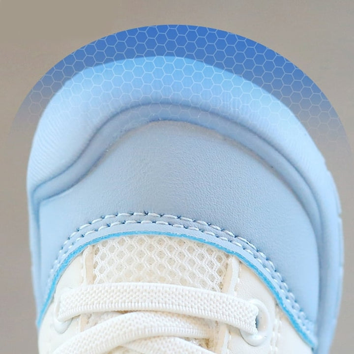 Happy baby in comfortable, flexible barefoot shoes, perfect for playtime & natural foot development.