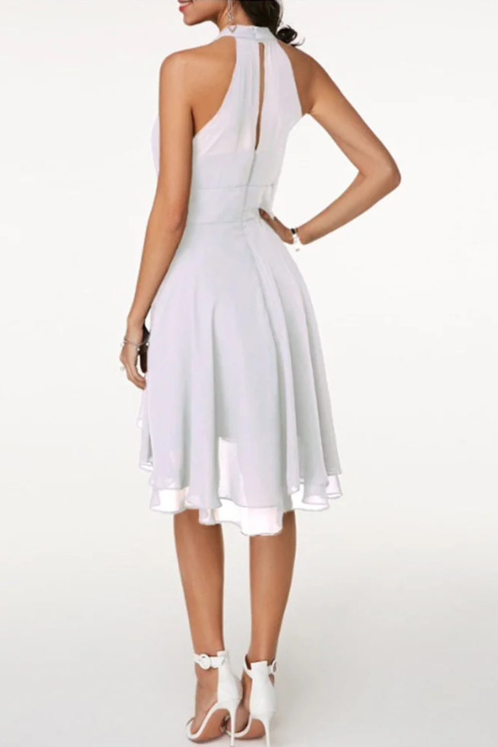 Trendy women's occasion wear: flowy halter neck tiered mini dress with a feminine ruffle hem.