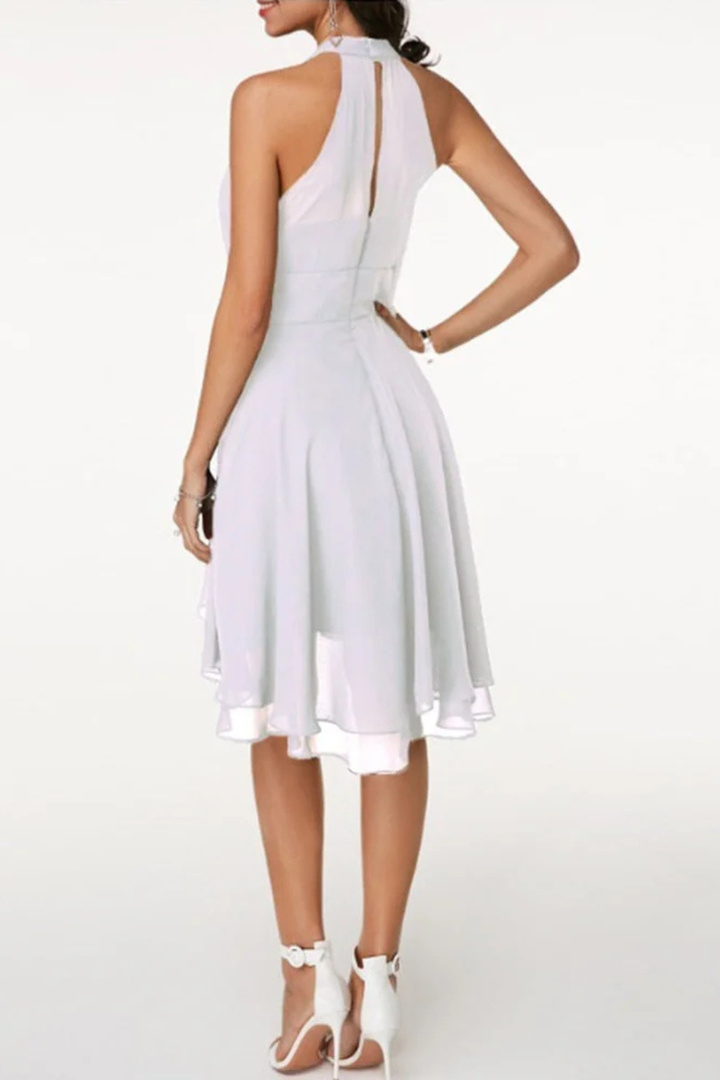 Trendy women's occasion wear: flowy halter neck tiered mini dress with a feminine ruffle hem.