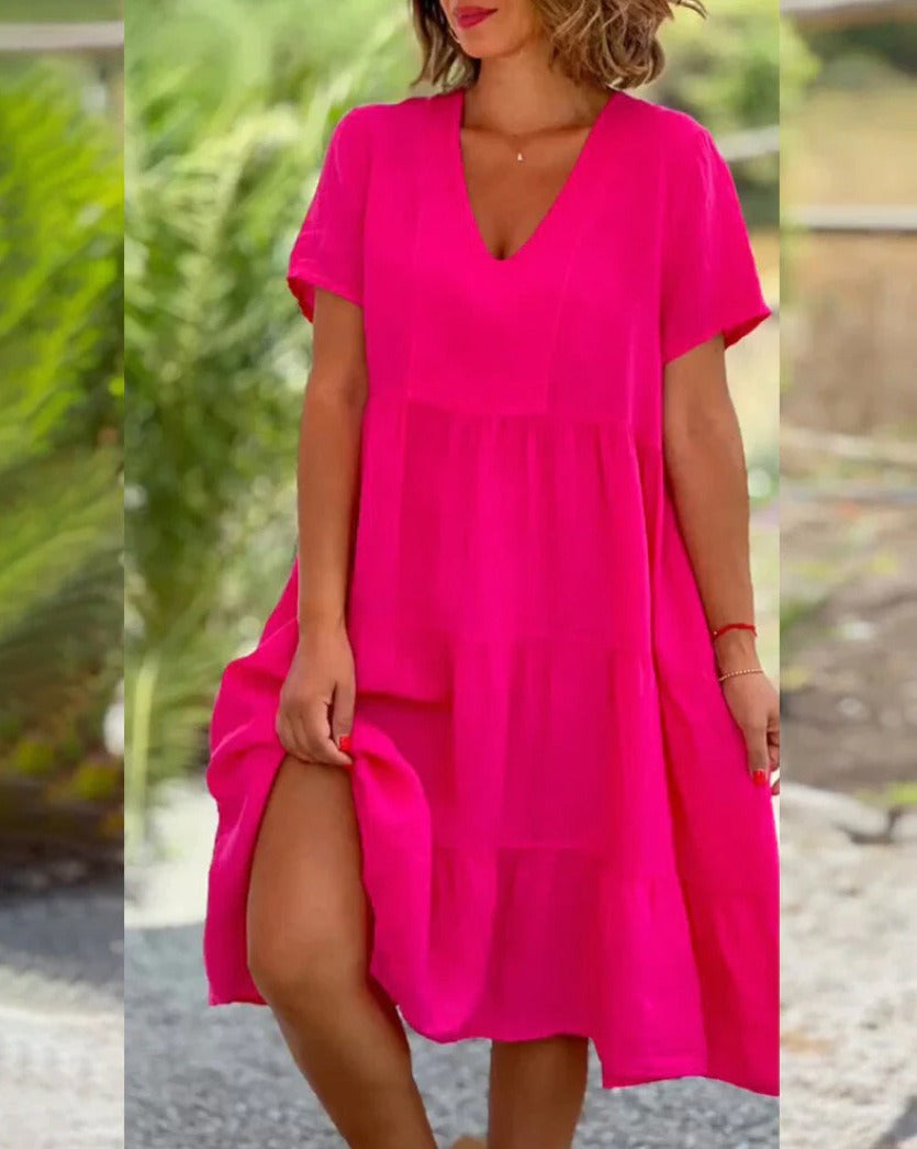 Flowy pink women's summer midi dress with ruched sleeves, V-neck, and ruffle hem, ideal for casual wear.