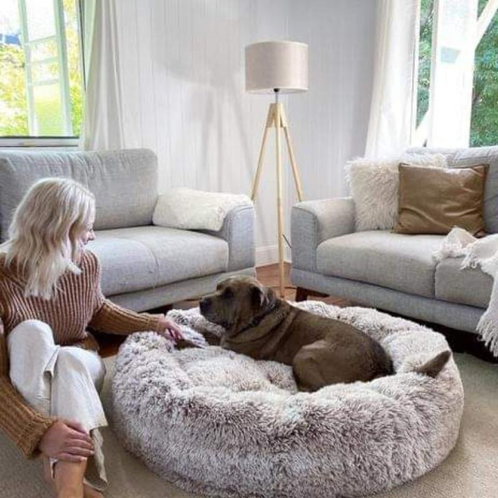 Luxury calming donut dog bed, fluffy faux fur, designed for anxiety relief & deep sleep. Pet supplies.