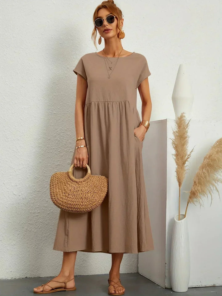 Timeless elegant women's midi dress, relaxed fit & fluid, ideal for spring occasion wear.