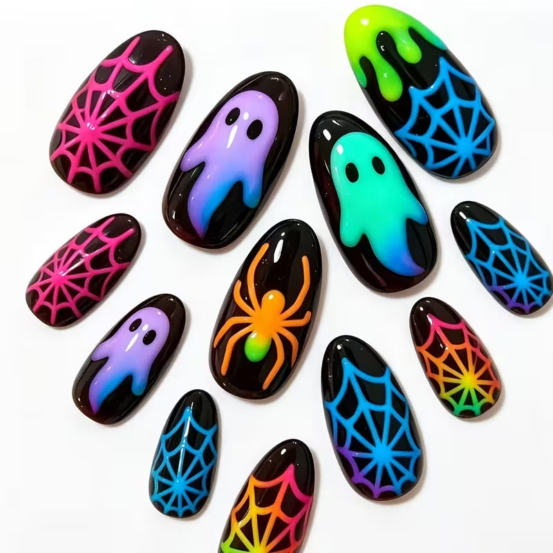 Women's glow-in-the-dark Halloween press-on nail set with spooky ghost, spider & skull nail art for costume parties.