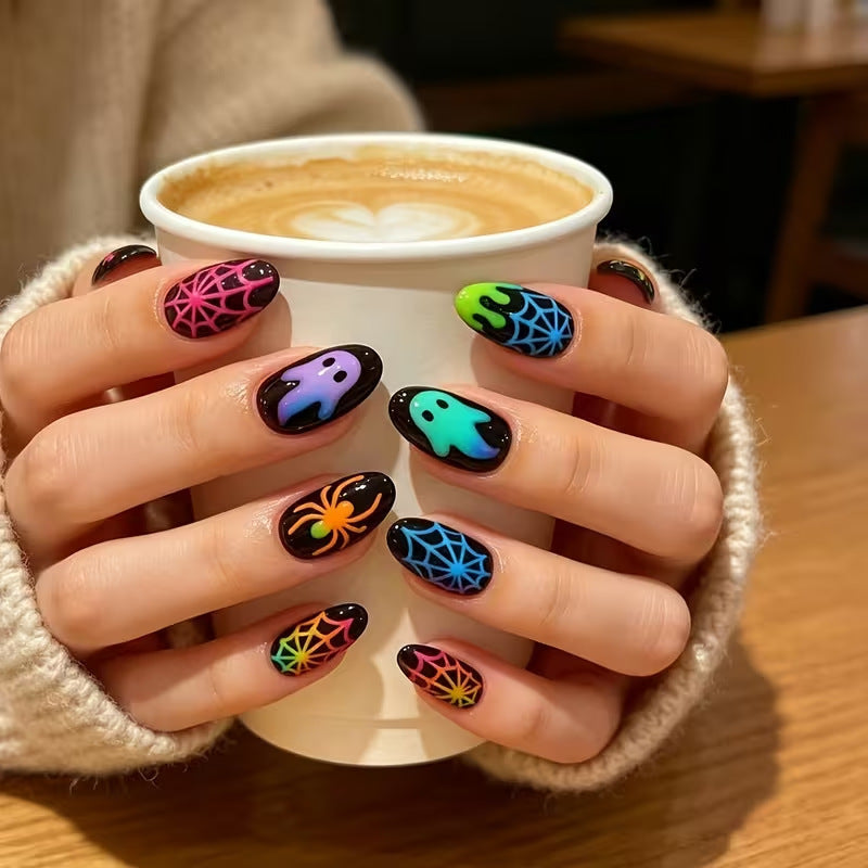 Spooky Halloween press-on nail art for women. Fluorescent ghost, spider & pumpkin designs that glow in the dark.