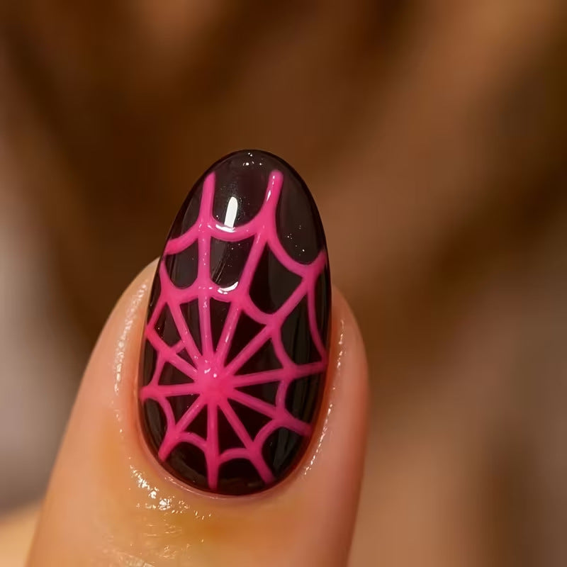 Glow-in-the-dark fluorescent press-on nails for women. Spooky Halloween costume party nail art with ghost & spider details.