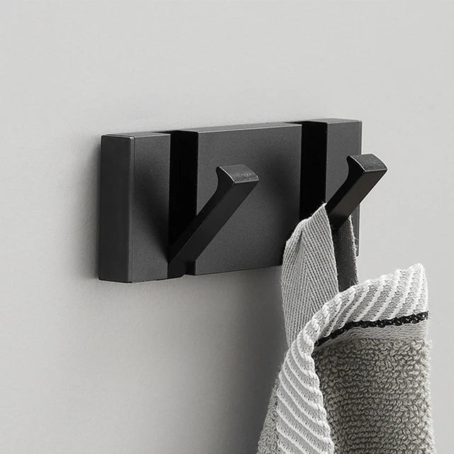 Black modern foldable wall hook, ideal for entryway coat & hat storage, decluttering.