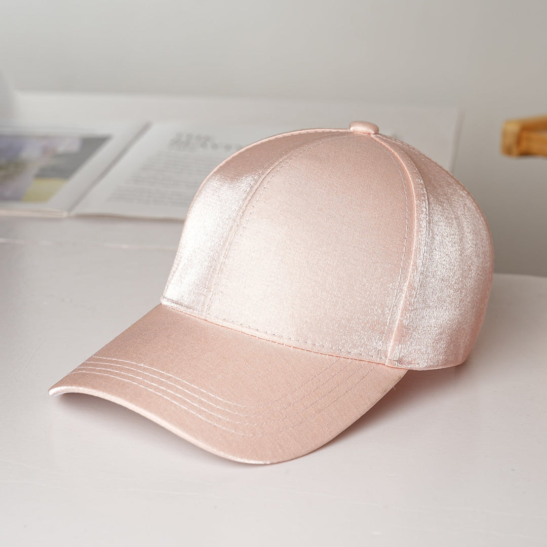 A fashionable women's baseball cap made from luxurious satin, combining sporty function with elegant style.