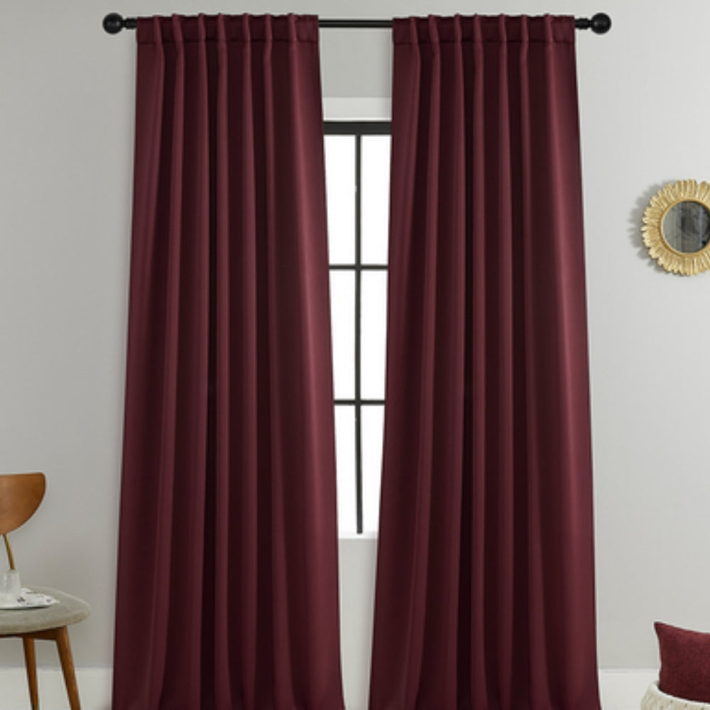 Stylish black blackout window treatments, excellent for noise reduction and creating a serene bedroom environment.