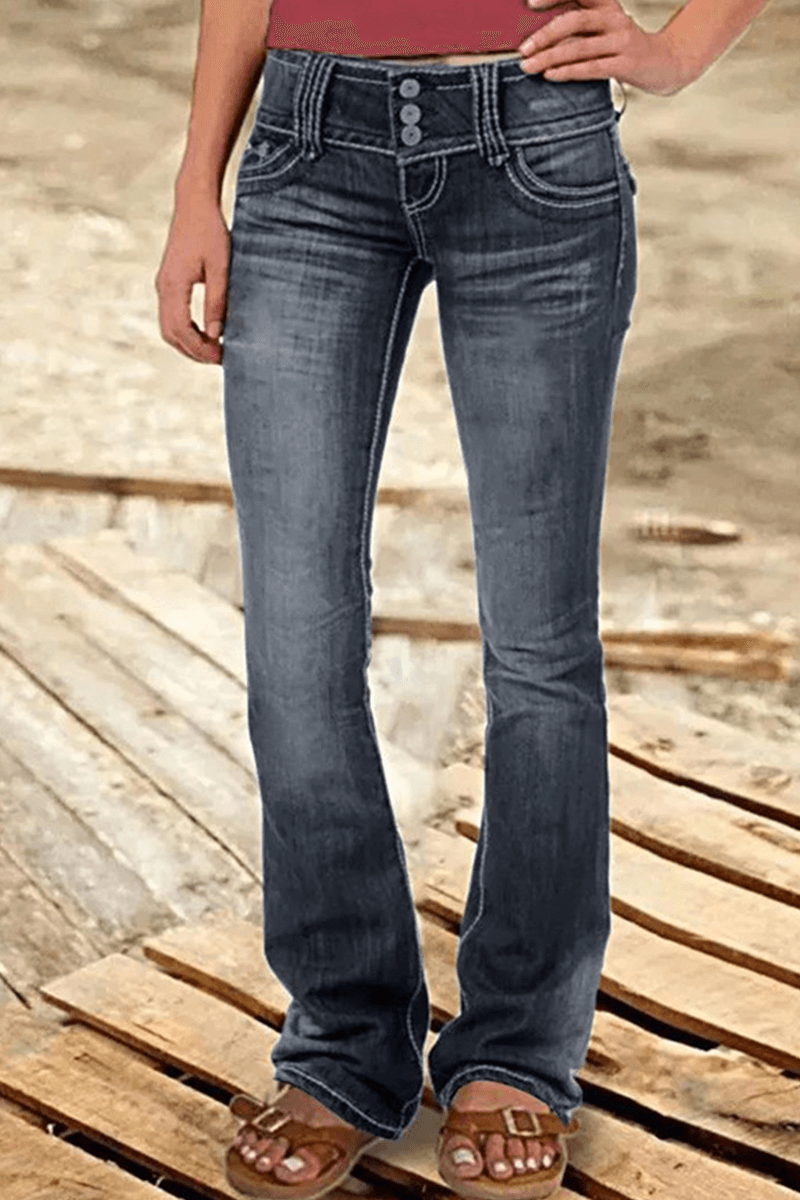 Detail of the bootcut hem and ripped design on these versatile women's high-waisted jeans.