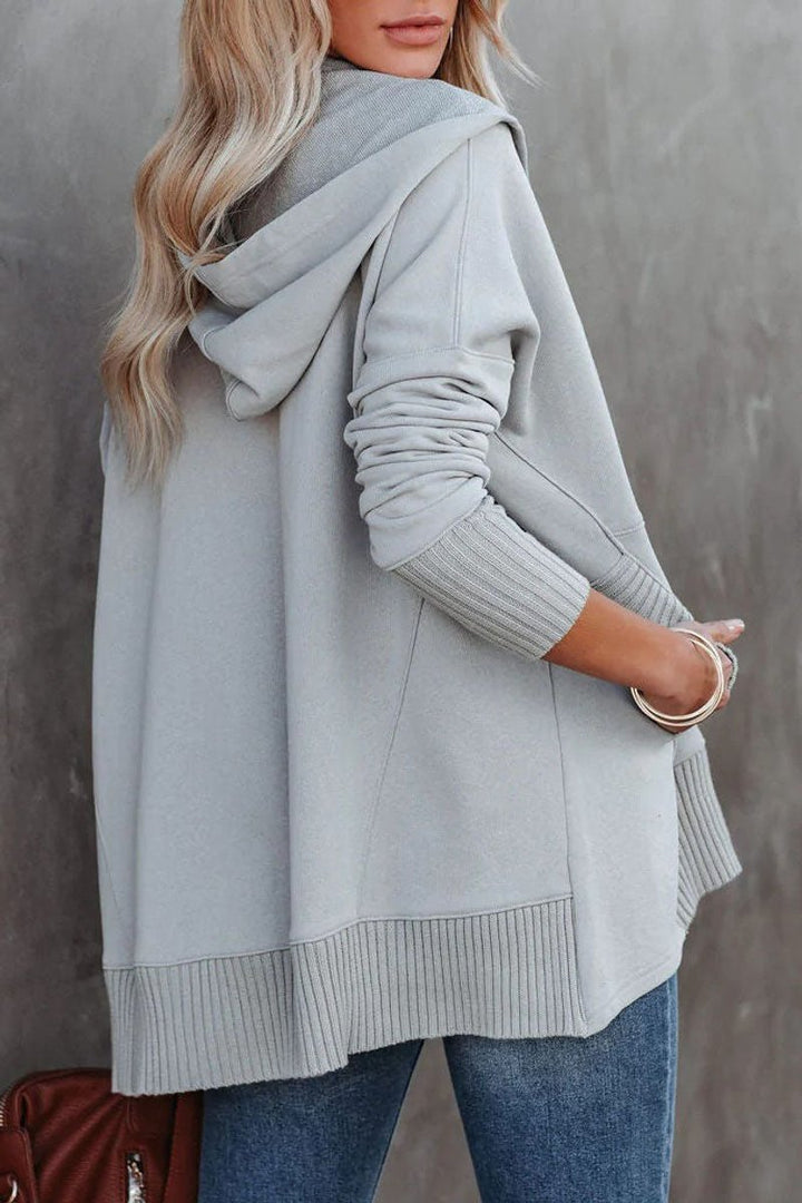 Detail of the comfortable hooded neckline and drawstring on a women's longline tunic sweatshirt.
