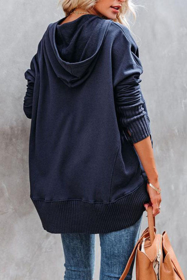 Front view of a women's grey longline hooded tunic sweatshirt, featuring practical pockets and drawstring.