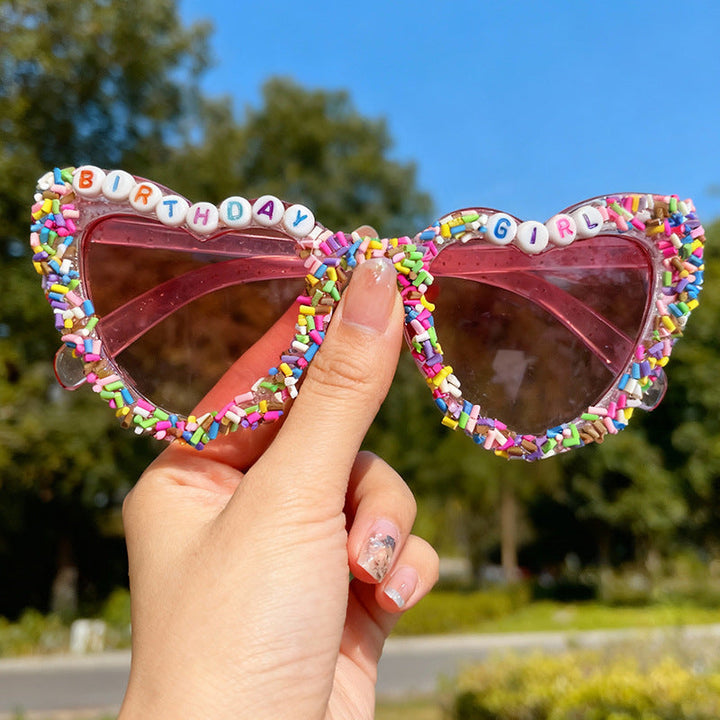 Women's heart-shaped birthday glasses with UV protection. Festive fun sunglasses, great party accessory & photo prop.