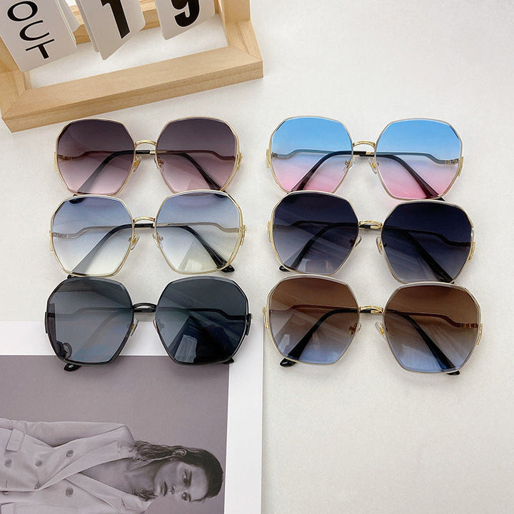 Geometric fashion sunglasses with black frames, offering UV protection, perfect for a trendy unisex look.
