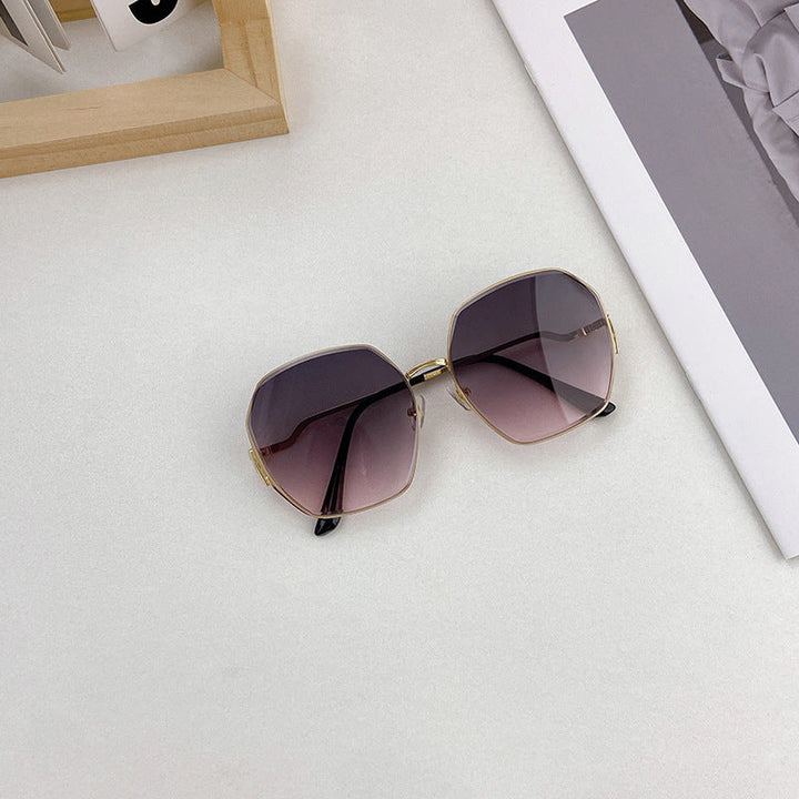 Distinctive geometric sunglasses with a sleek black frame, offering essential UV protection for all.