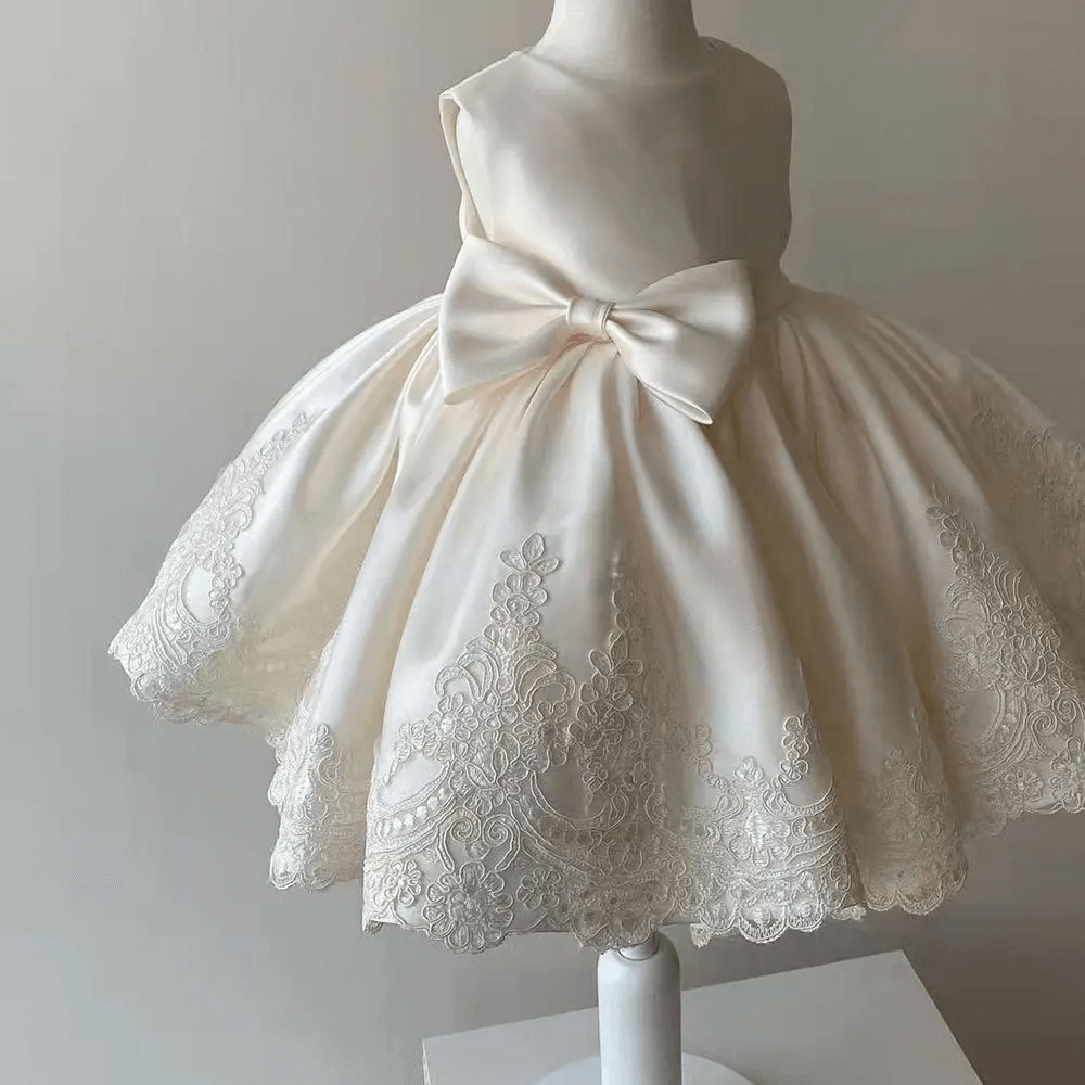 Luxury girls' Aurora princess dress featuring delicate lace trim, a charming bow, ideal for any special occasion.