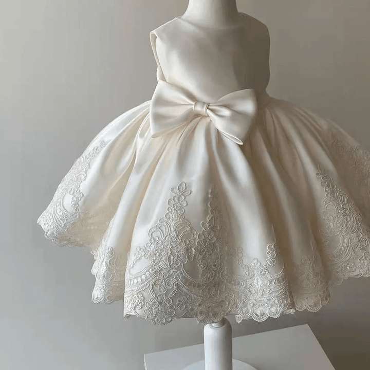 Luxury girls' Aurora princess dress featuring delicate lace trim, a charming bow, ideal for any special occasion.