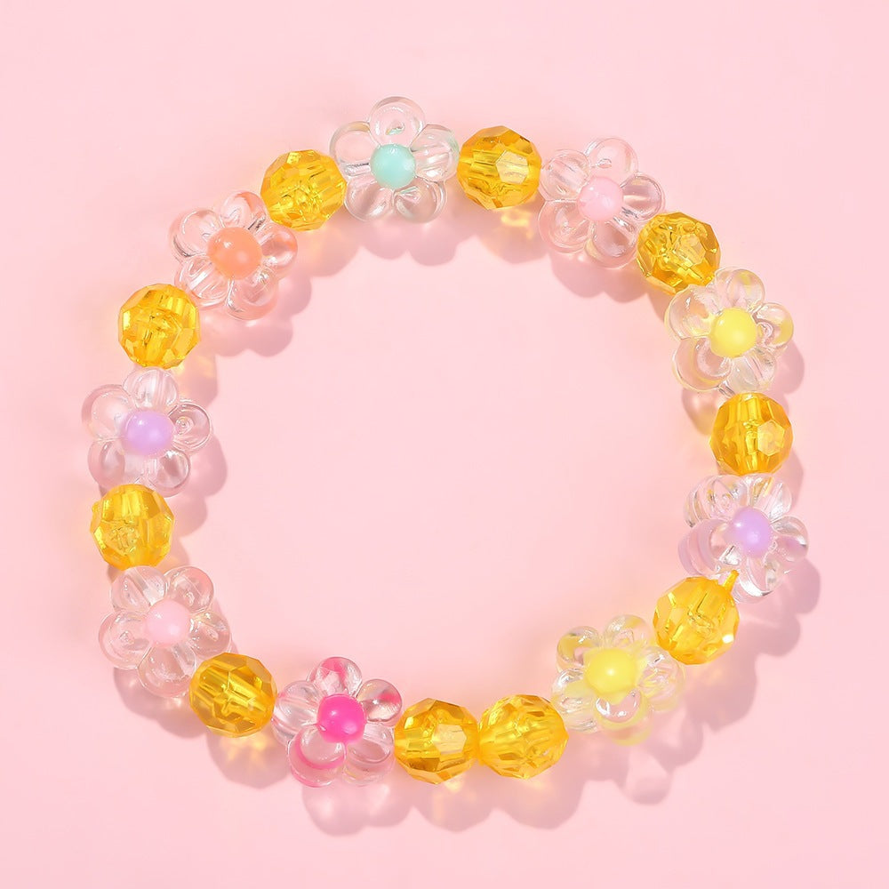 Cheerful girls' friendship bracelet, adorned with colorful flower motifs and shiny beads.