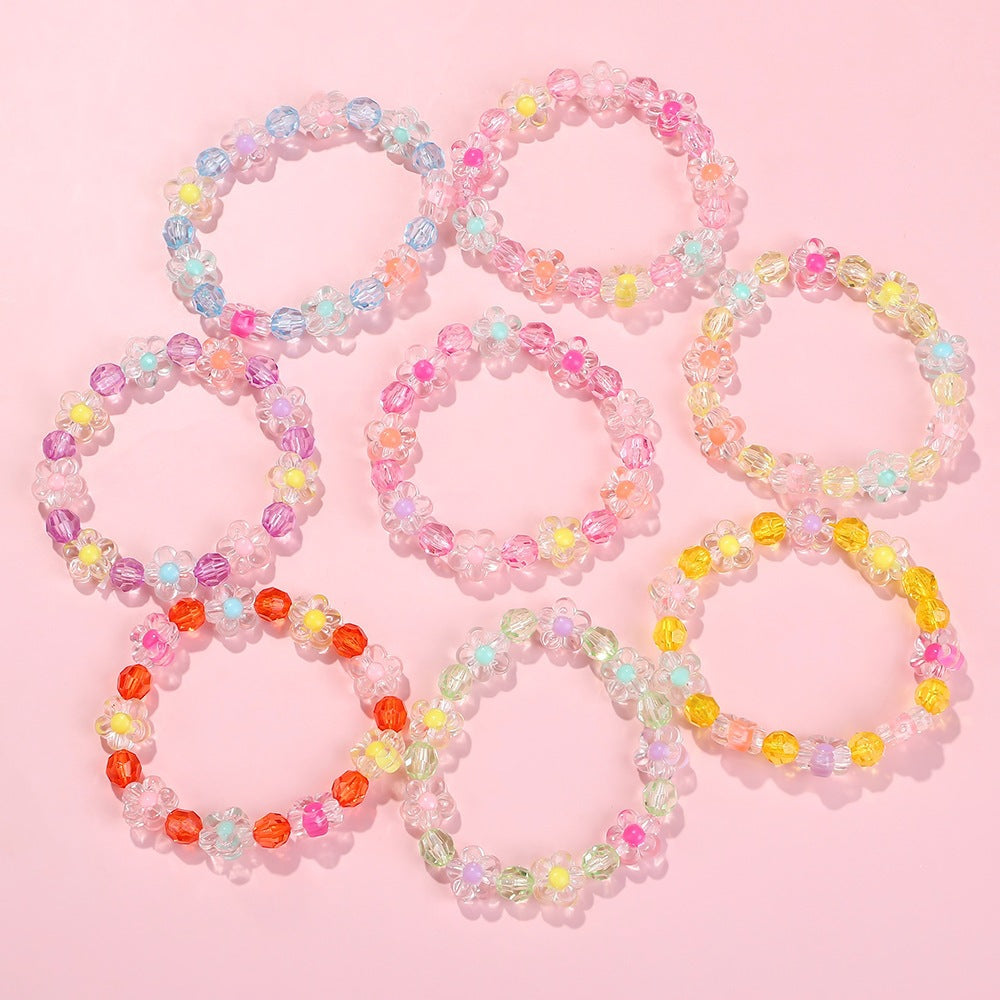 Close-up of a vibrant floral friendship bracelet featuring diverse colorful flower motifs.