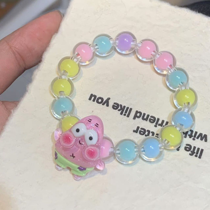 Perfect cheerful gift: Girls' colorful elastic bracelet with playful plastic cartoon character pendants.