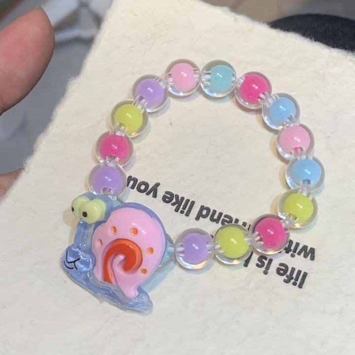 Girls' cheerful elastic bracelet with bright plastic cartoon pendants, colorful and playful kids' jewelry.
