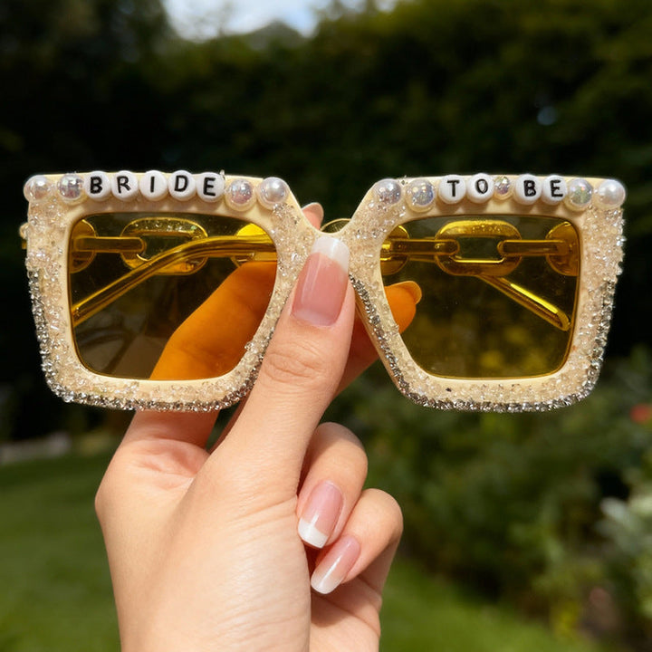 Fun "Bride" rhinestone & pearl sunglasses for bachelorette parties, a must-have wedding accessory.