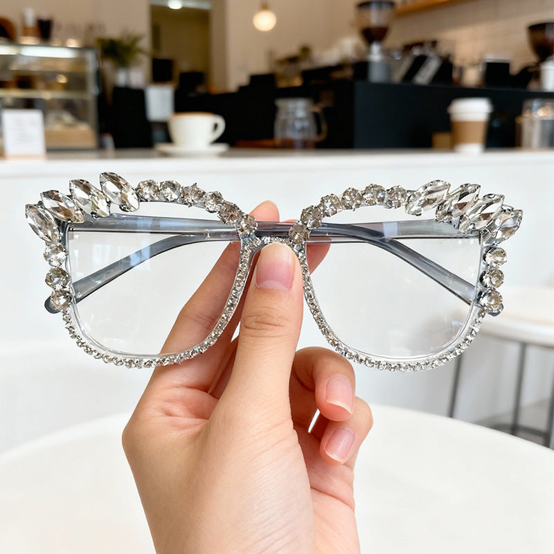 Glamorous women's cat-eye sunglasses with sparkling rhinestone frames, offering UV protection and high fashion.