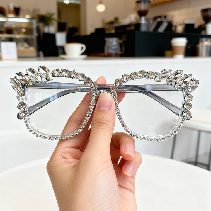 Glamorous women's cat-eye sunglasses with sparkling rhinestone frames, offering UV protection and high fashion.