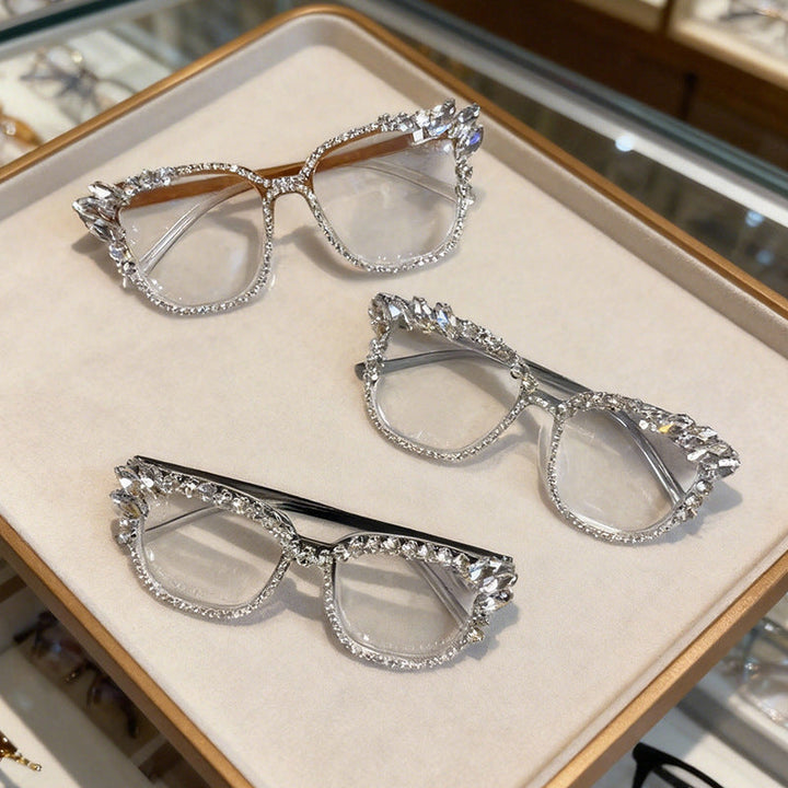 Close-up of sparkling rhinestone details on chic women's cat-eye sunglasses, a glamorous fashion eyewear accessory.